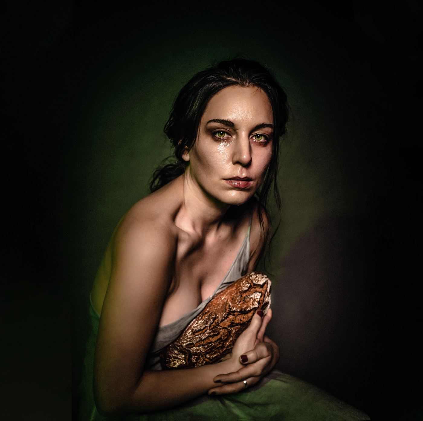 Painterly portrait holding bread, green light