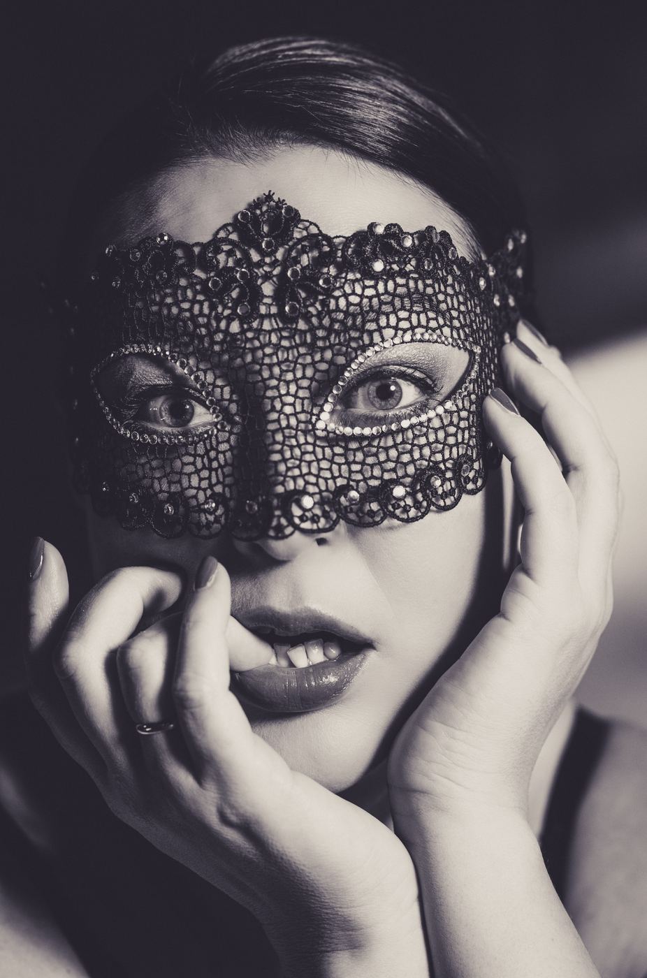 Portrait behind a black lace mask