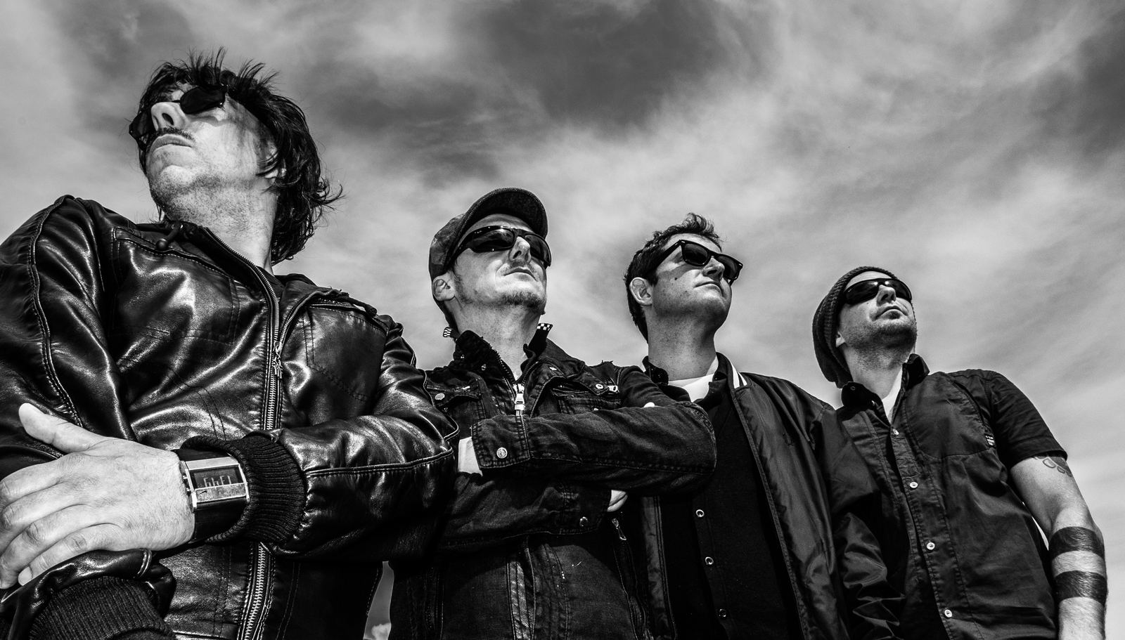Black and white band portrait against the sky