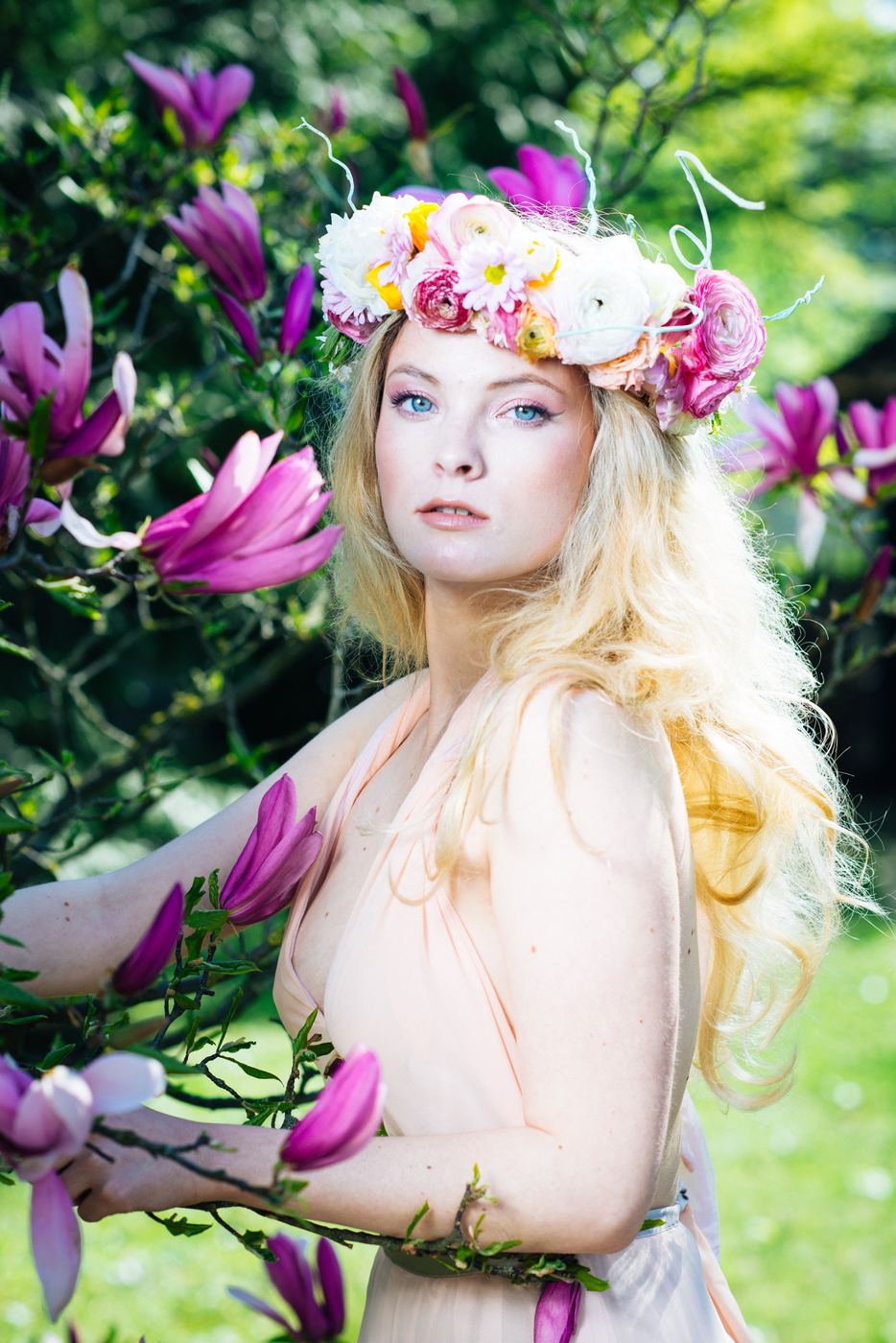Portrait with flower crown among magnolias